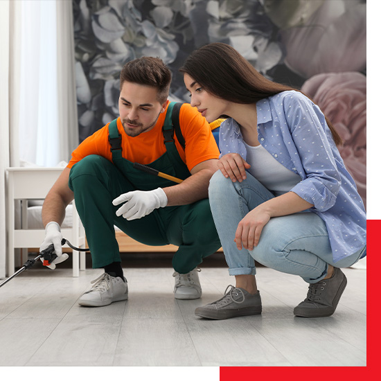 pest control technician showing customer where he is spraying