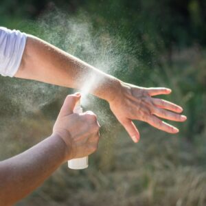 person applying insect repellent 