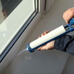putting caulking around a window