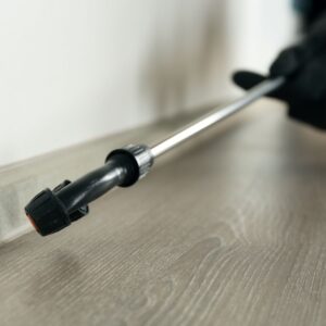 Pest control technician spraying a protective solution