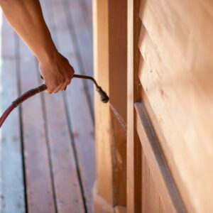 Chemical spray being applied to a wall